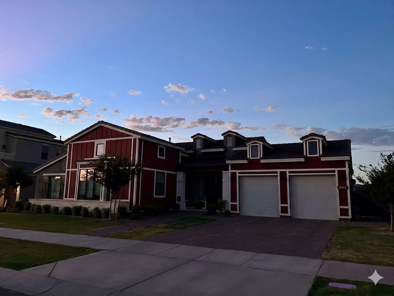 The same Phoenix home at dusk before landscape lighting, with the exterior unlit